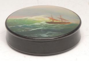 A Russian lacquer circular snuff box, the push-fitting cover painted with a ship on a stormy sea,