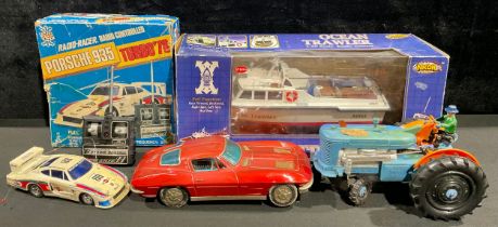 A tin plate battery operated red racing car, M - 101, 29cm wide; a Tricky-Tommy Tractor, battery