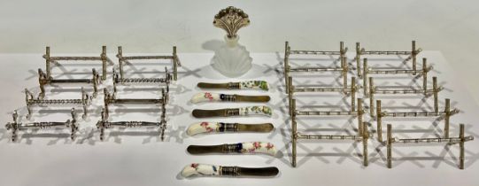 A collection of nine Victorian silver plated pairs of knife rests; A set of six miniature knives,