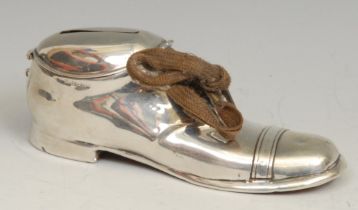 An Edwardian silver novelty money box, as a shoe, hinged cover, 13cm long, S Blanckensee & Son