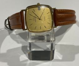 A gentleman's 9ct gold Marvin watch, rounded square face, baton indicators, centre seconds, date