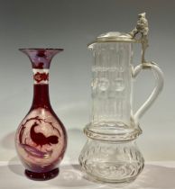 An early 20th century Bavarian cut glass ale jug or pitcher, pewter mounted, the thumb piece as