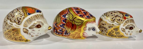 A pair of Royal Crown Derby paperweights, Hawthorn Hedgehog and Bramble, gold stoppers; another,