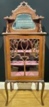 An Art Nouveau music room cabinet, bevelled mirror, glazed door enclosing two shelves, pad feet,