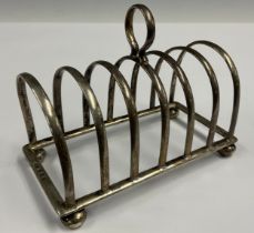 A silver seven bar toast rack, by Adie Brothers, Birmingham