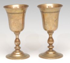A pair of 19th century travelling pedestal cups or Communion chalices, each bell shaped bowl screw-