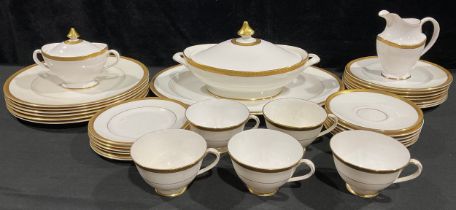 A Royal Doulton Royal Gold pattern dinner service, H 4980, applied with raised tooled gilt borders