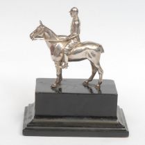 A George V silver equestrian model, cast as a polo player on horseback, ebonised base, 14cm high
