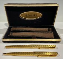 A pair of Parker gilt metal pens, roller ball and fountain, made in France, each with soft cover,