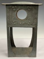 An Art Nouveau domed pewter clock case, the vacant aperture flanked by a pair of stylised sinuous