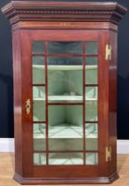An early 20th century mahogany inlaid corner cabinet, Greek key design to cornice, brass escutcheon,