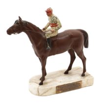 An Art Deco period painted spelter equestrian model, of a horse and jockey, the marble base with