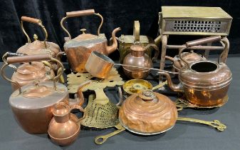 A Victorian copper kettle; others, Victorian and later; a brass hot water can; a brass and iron