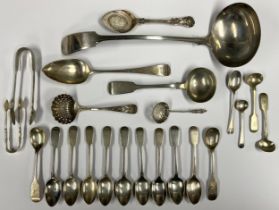 A silver fiddle pattern ladle; a quantity of silver fiddle pattern teaspoons; a silver tea strainer;