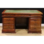 An oak twin pedestal desk, rectangular top with inset writing surface above three frieze drawers,