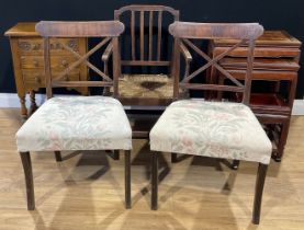 An oak provincial armchair, rush seat, fluted spindles, 84cm high; a pair of mahogany side chairs,