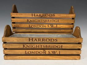 A pair of wooden troughs with metal inserts, each advertising Harrods, Knightsbridge, London, S.W.1,