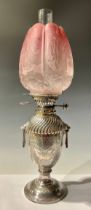 A Victorian silver plated urn shaped oil lamp, the top spirally fluted above a pair of angular