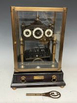 A Congreve brass rolling ball perpetual clock, three dials each with white enamel chapter ring,