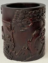 A contemporary Chinese hardwood brush pot, carved in relief with trees and flowers, 13cm high