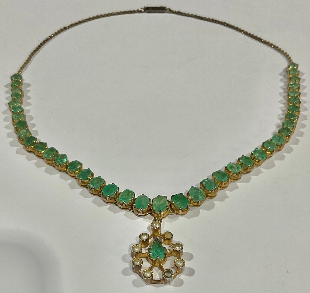 A gold plated necklace, set with a strand of graduated faceted oval emeralds, suspended with a - Image 2 of 2