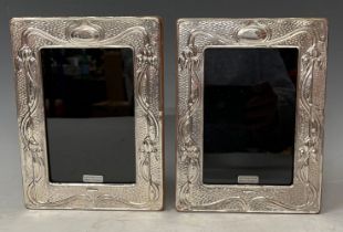 A pair of contemporary Art Nouveau style hallmarked silver photograph frames, wooden easel backs,