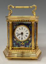 A French lacquered brass hexagonal carriage clock, applied with champlevé panels, swing handle,