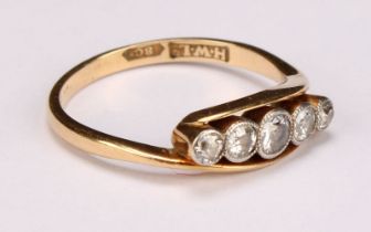 An 18ct gold ring, set with five graduated diamonds, size M, marked 18ct, 2.7g