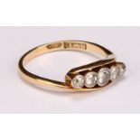 An 18ct gold ring, set with five graduated diamonds, size M, marked 18ct, 2.7g