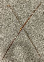 A hardwood longbow, 179.5cm long; An early 20th century palmwood walking stick or staff, possibly