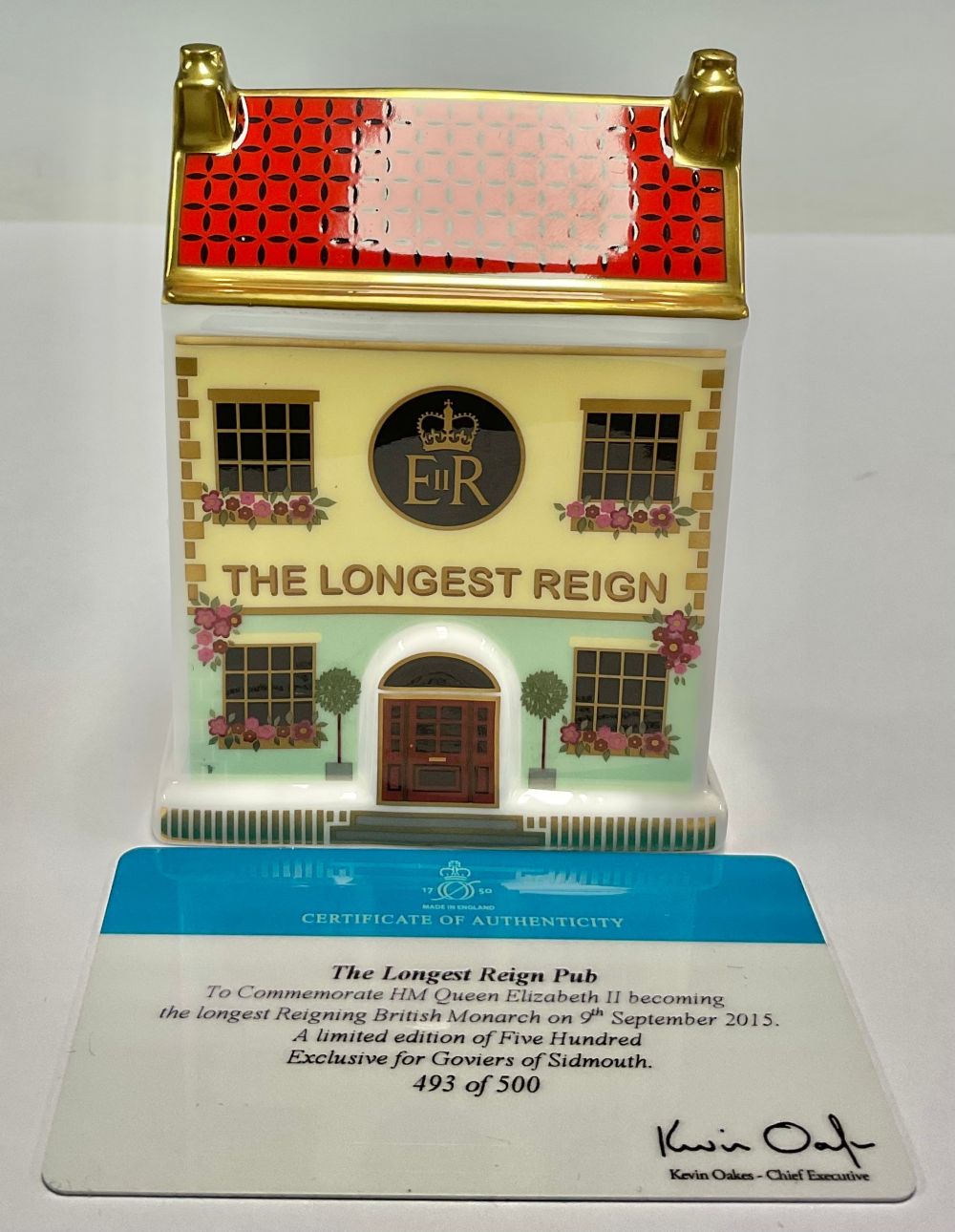 A Royal Crown Derby miniature model of a house, The Longest Reign Pub, 10cm high, commemorates HRH