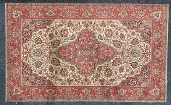 A Middle Eastern woollen rug or carpet, central diamond shaped medallion, within a field of