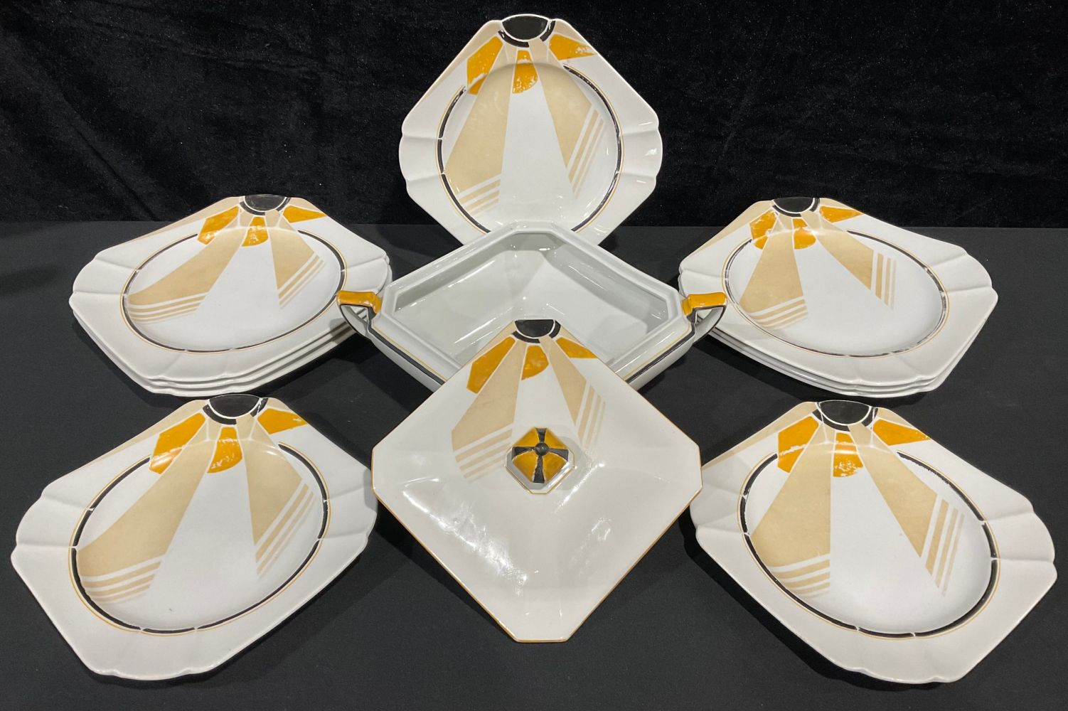 A Shelley Vogue Sunray pattern part dinner service, comprising tureen, dinner plates and dessert