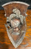 A Black Forest Knights feathered helmet and shield wall bracket