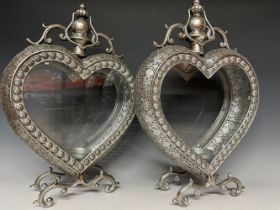 A pair of silver coloured pierced metal heart shaped lanterns, with decoration in relief, 51cm high