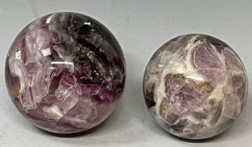 A polished flourite sphere, approx. 7.5cm diameter; another, similar, approx. 6.5cm (2)