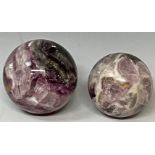 A polished flourite sphere, approx. 7.5cm diameter; another, similar, approx. 6.5cm (2)