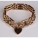 A 9ct rose gold gate link bracelet, set with seven oval cut garnets, love heart clasp and safety
