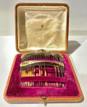 A pair of cased Art Nouveau hair slides, with gold and amethyst mounts, combs a/f, West and Son