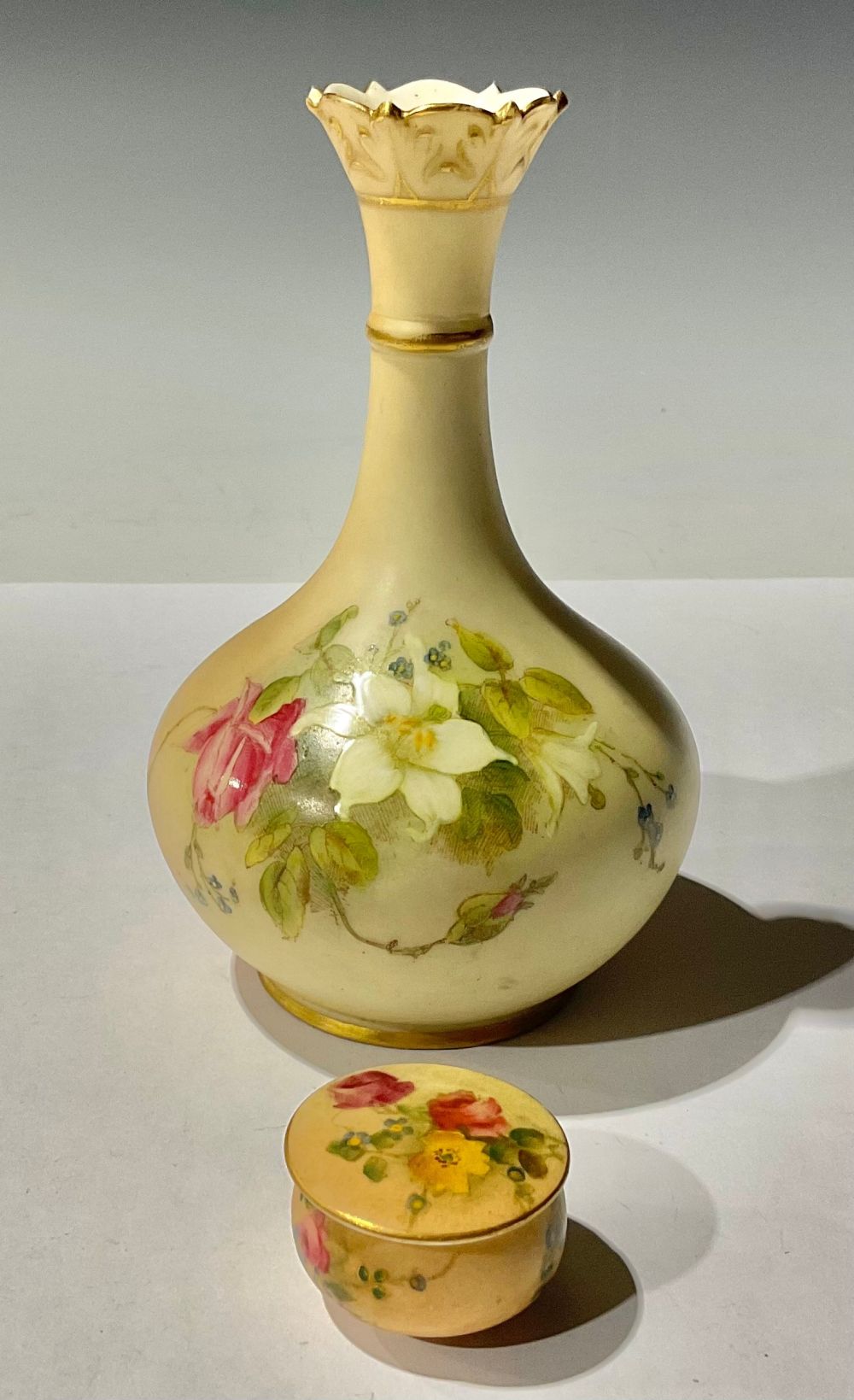 A Royal Worcester vase, painted with wild roses; a rouge pot and cover (2)