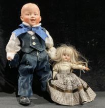 Toys & Juvenalia - a bisque head and doll, the bisque head inset with fixed brown glass eyes,