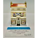 A Royal Crown Derby miniature model house, St James’s Millinery and Military Tailors, celebrating