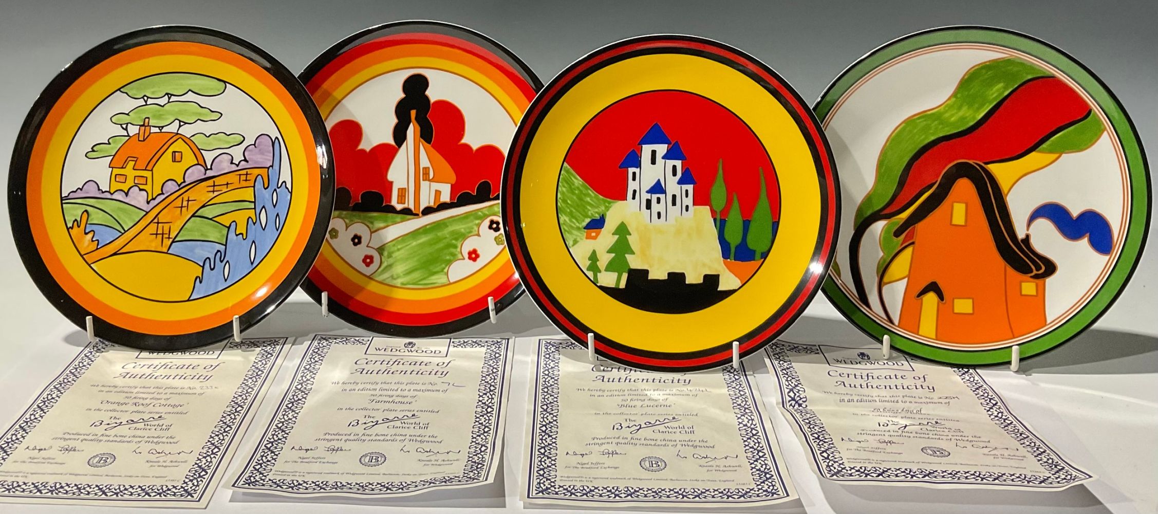 A set of four Wedgwood, Clarice Cliff Bizarre collector's plates, Farmhouse, Blue Lucerne, Orange