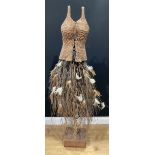 A rustic wicker display mannequin, wicker bodice, hazel twig and feather skirt, on wooden stand,