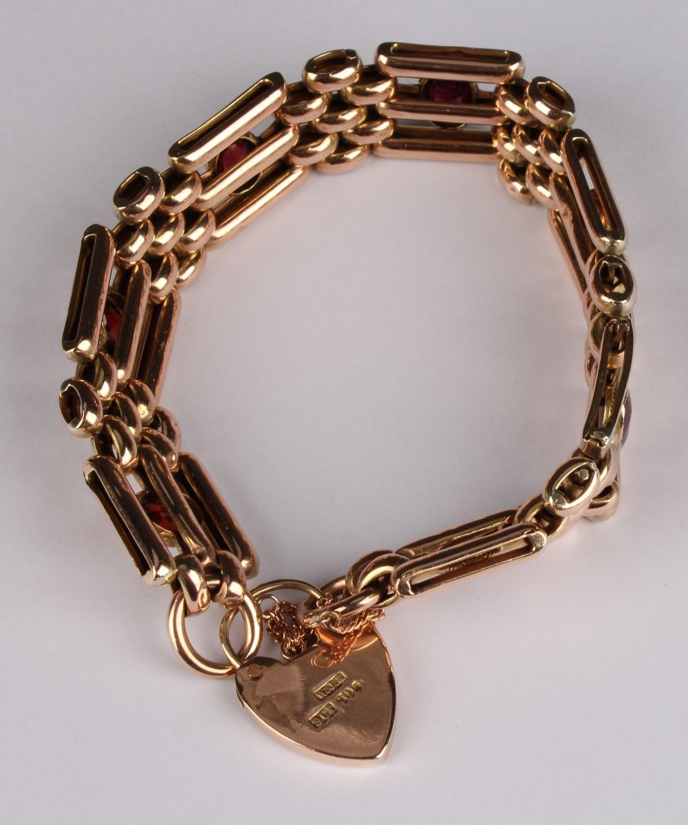 A 9ct rose gold gate link bracelet, set with seven oval cut garnets, love heart clasp and safety - Image 2 of 2