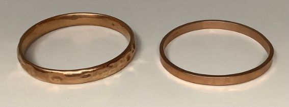 A 9ct rose gold bangle, marked 375, Chester hallmark; another similar, 30g gross (2)