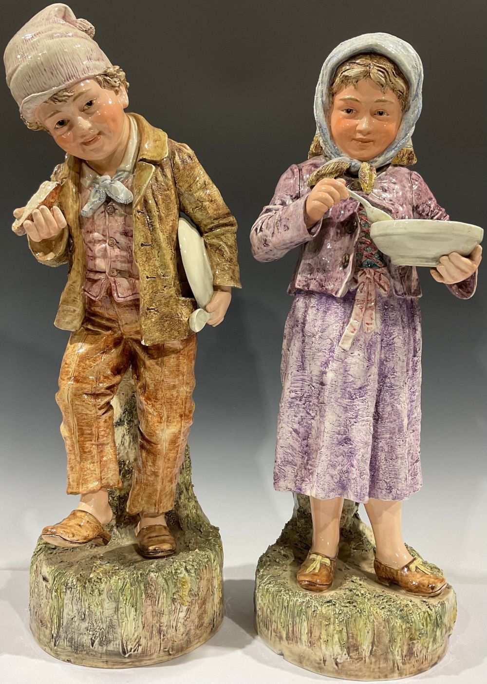 A large pair of 19th century continental porcelain figures, as rural children, each 56cm high (2)