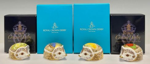 A group of four Royal Crown Derby paperweights, Primrose Hedgehog and Strawberry Hedgehog, gold