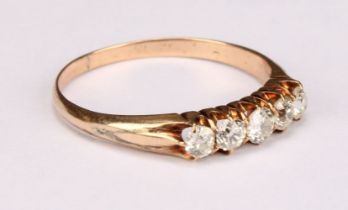 A five stone diamond ring, the round brilliant cut stones claw set, yellow gold coloured metal