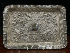 A Victorian silver rounded rectangular dressing table tray, repousse worked with foliate scrolls,